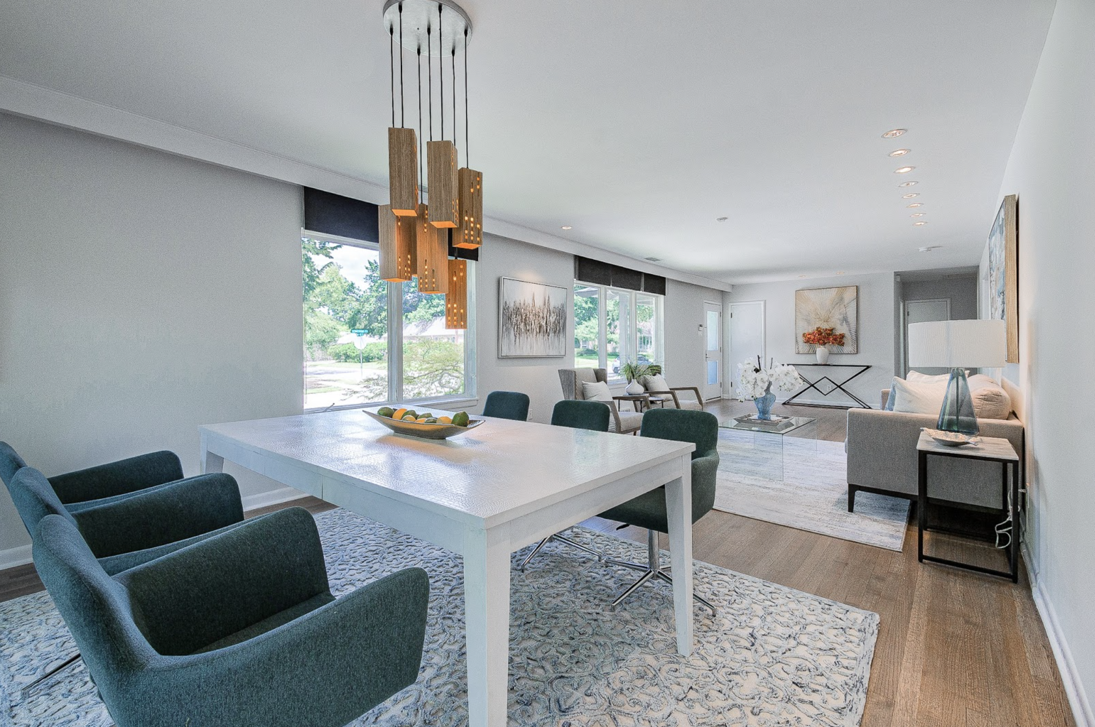 Open-concept Dallas living and dining area with white finishes and blue seating