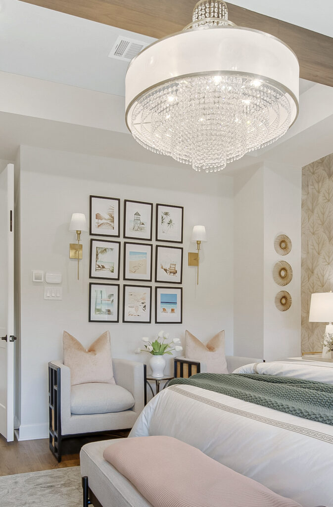 Lake Highlands primary bedroom with upholstered bed, sitting area and framed art wall