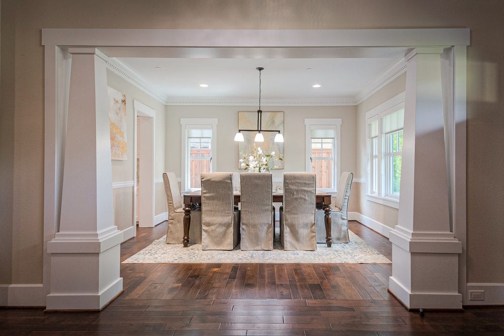 Elegant Lakewood dining room after luxury home staging by Design by KETI in Dallas, featuring a chandelier, dining table, and neutral decor.